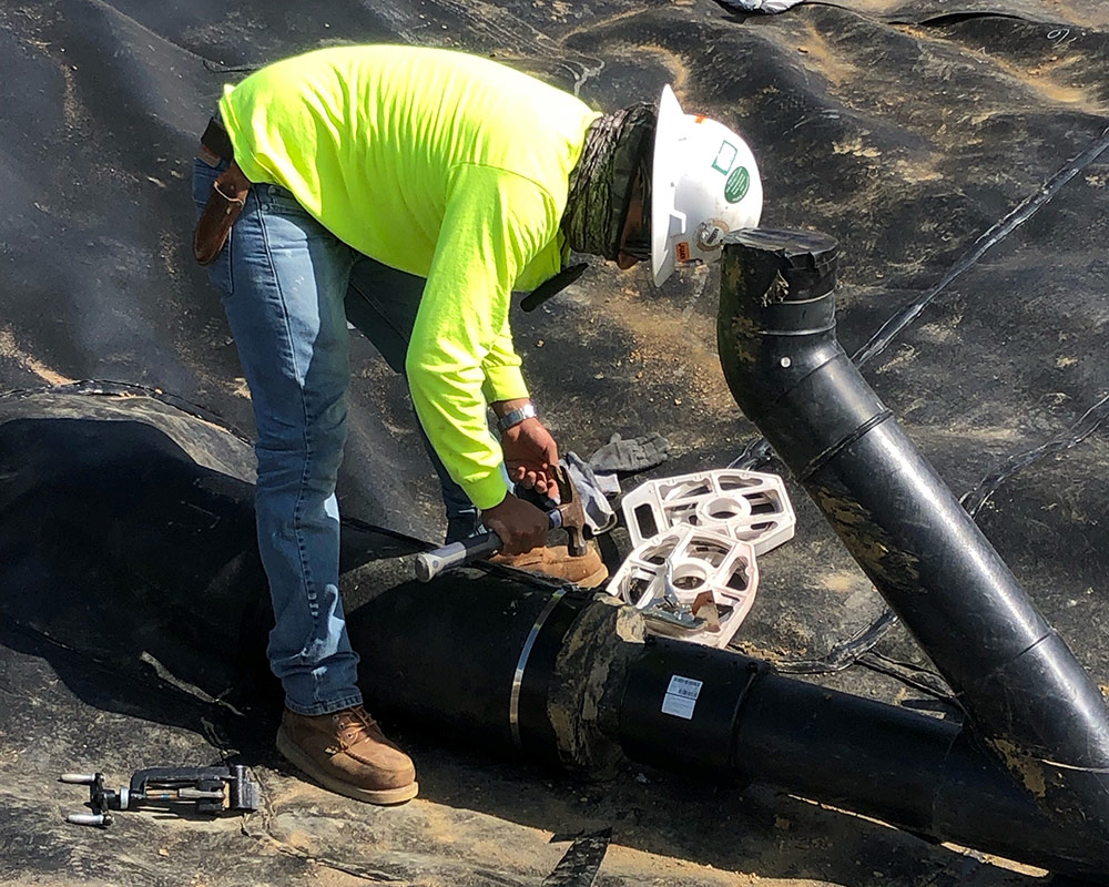 Installing the Boot Clamp Around an HDPE Pipe Boot Installed