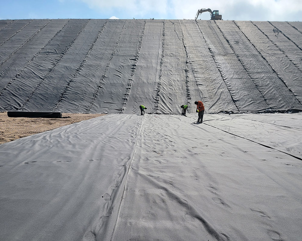 Crew Performing Non-Destructive Testing QA/QC on Completed Geomembrane Welded Seams
