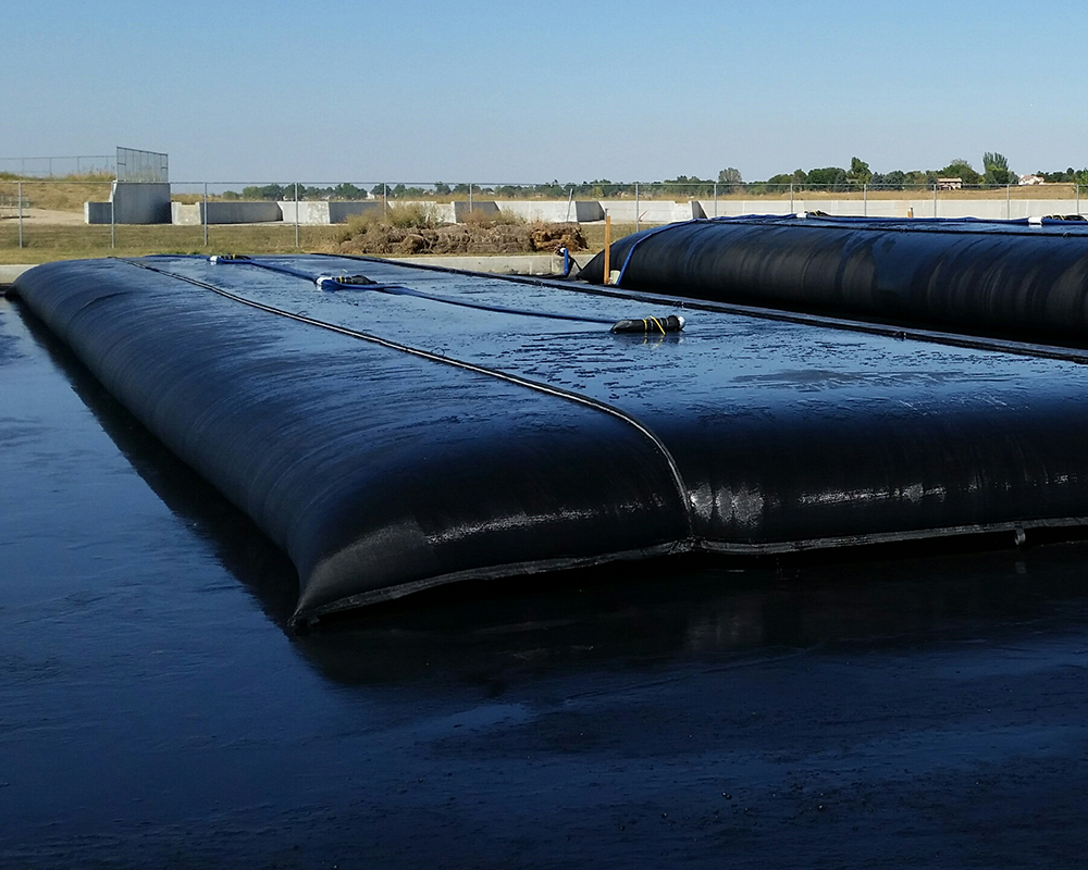 Two Geostrux Tubes on Laydown Pad, Left Tube is Settling and the Tube on the Right is Being Filled